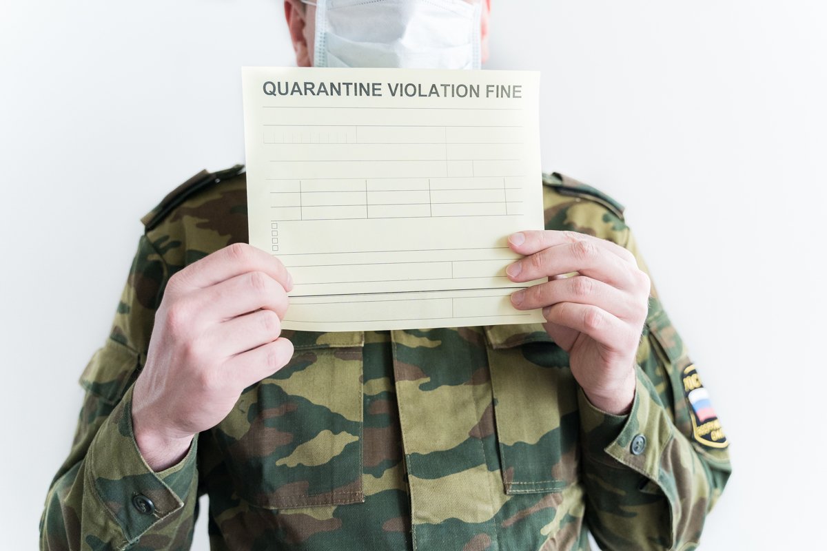 Police officer with self-isolation violation fine. Face mask example image 1