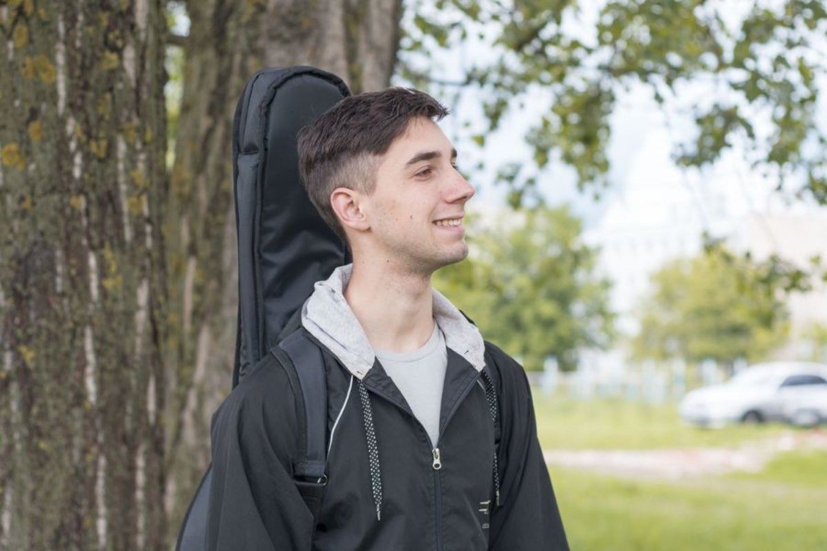 Young caucasian man with guitar in the park example image 1