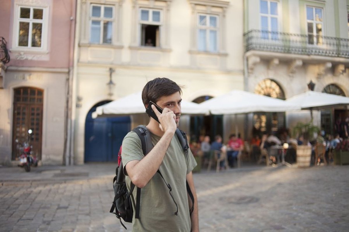 Young man walks in the city example image 1