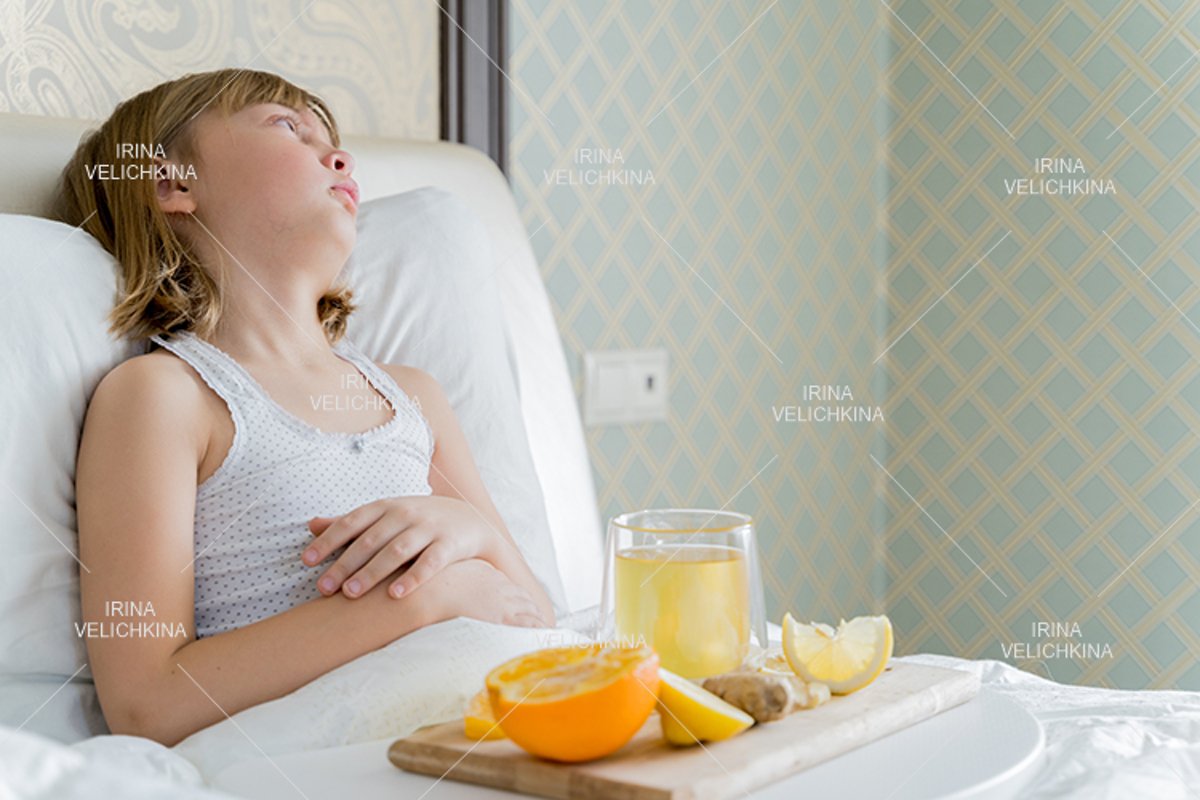 Sick girl in bed. Cup of flu drugs. Tea, orange,lemon,ginger example image 1