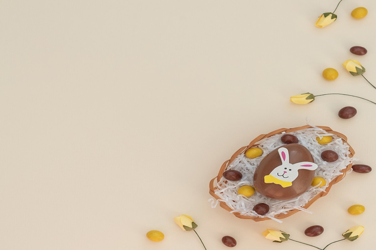 Colored brown and yellow choco Easter eggs in egg basket example image 1