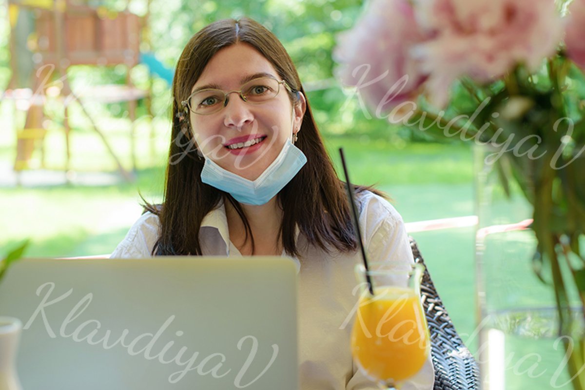 works at a laptop on the summer veranda example image 1