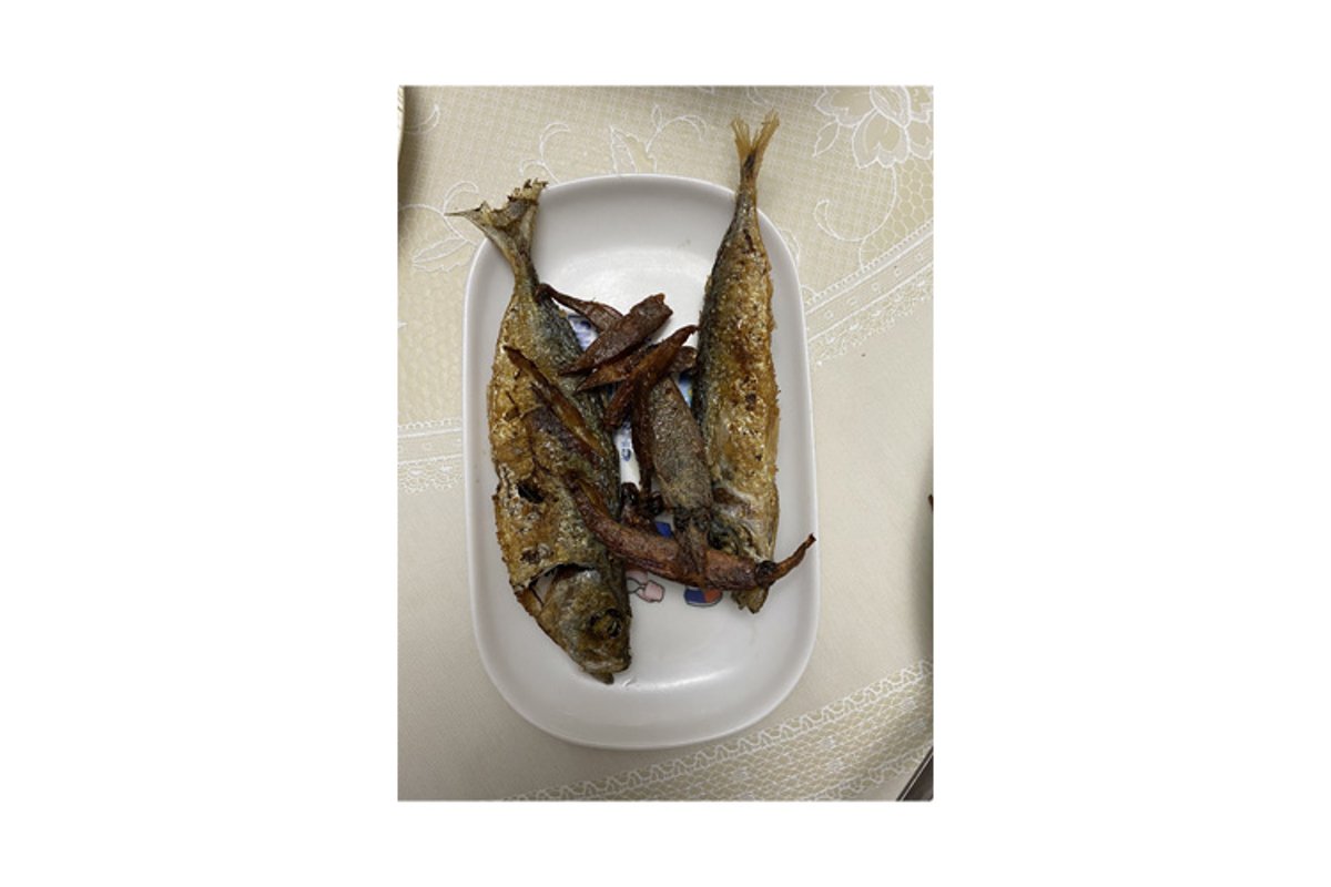 Photo of whole fried or grilled mackerel or oily fish example image 1