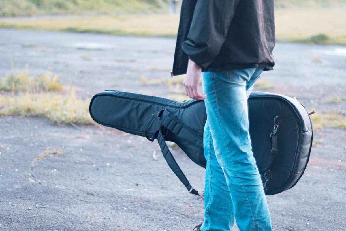 Man with acoustic guitar in a park example image 1