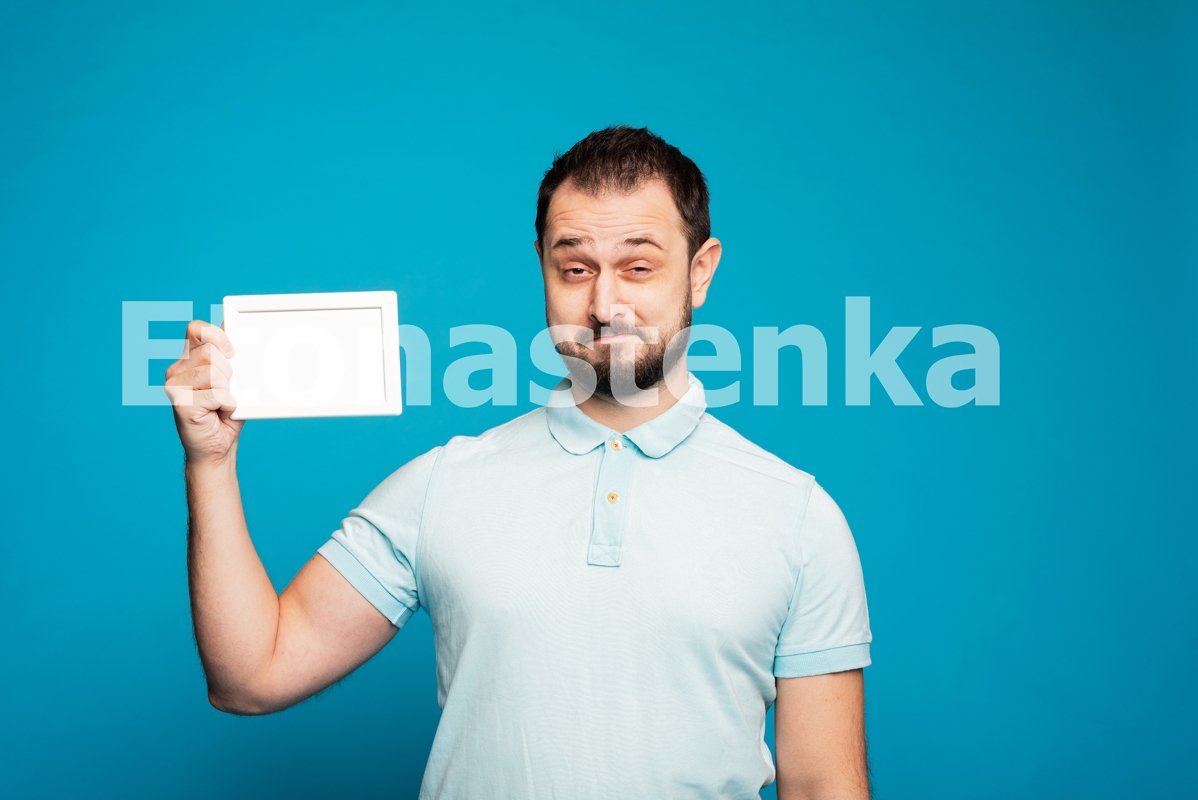 Happy millennial Caucasian guy on blue studio example image 1