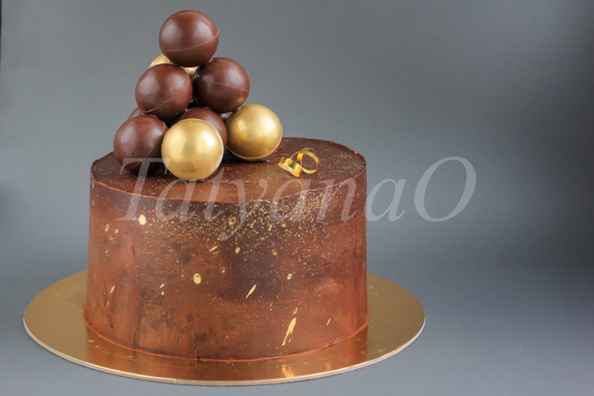 Chocolate birthday cake with gold decorations. example image 1