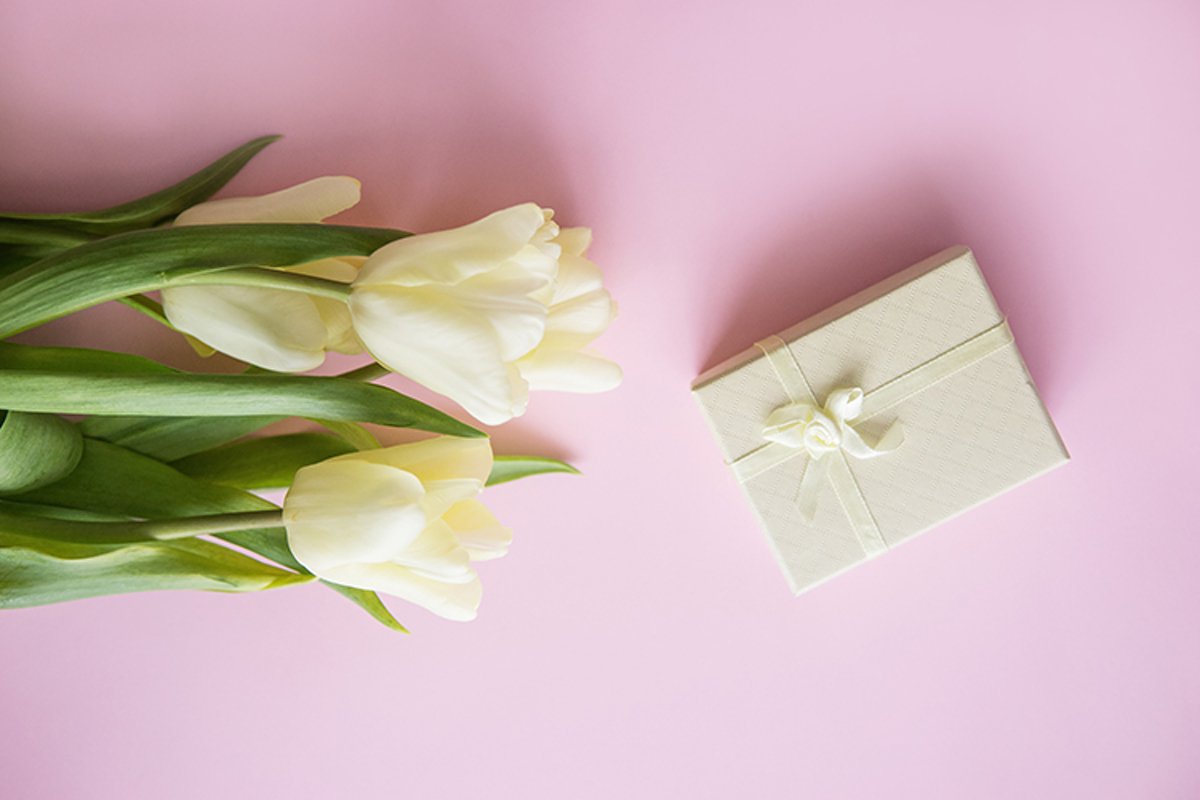 Yellow Tulip flowers are arranged on a pink background. example image 1