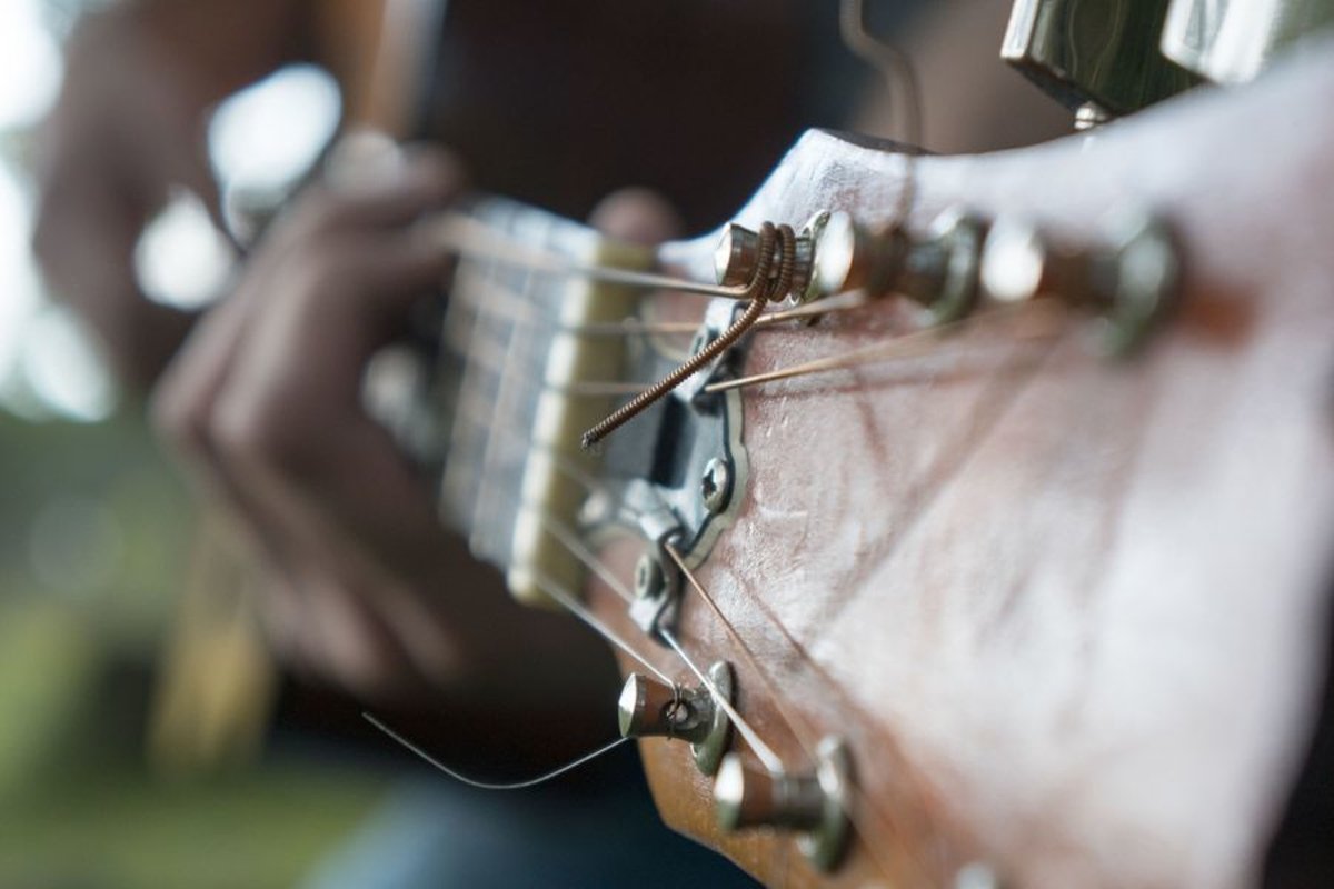 Young caucasian man with guitar in the park example image 1