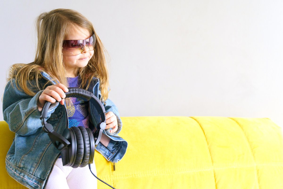 Little hipster girl in denim jacket in sunglasses. Fashion example image 1