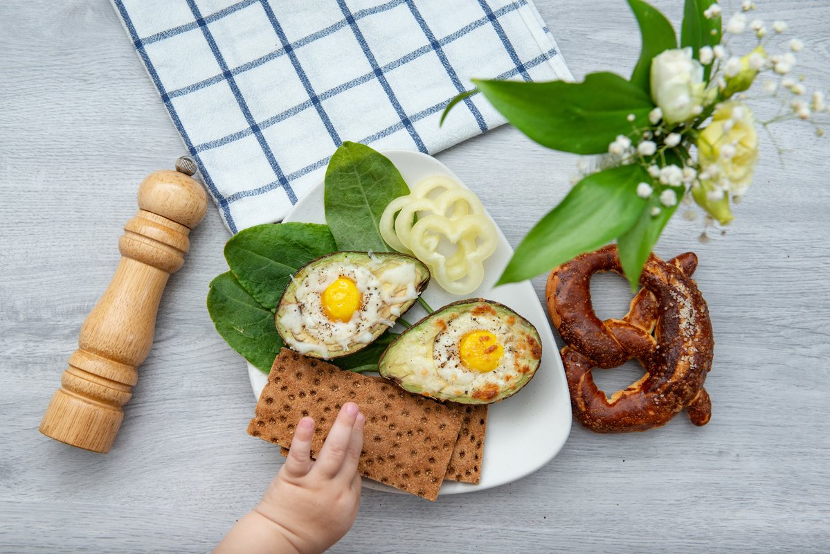 flat lay eggs baked in avocado on plate example image 1