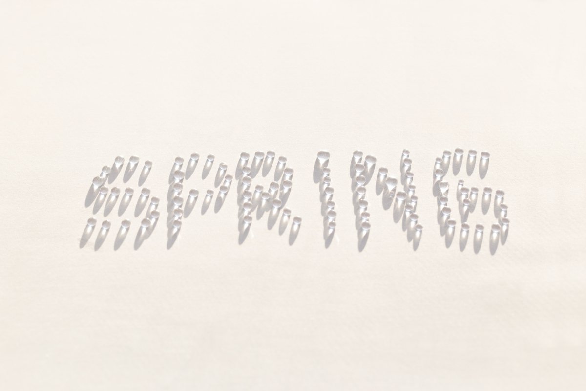 Word spring is created from drops of water. White background example image 1