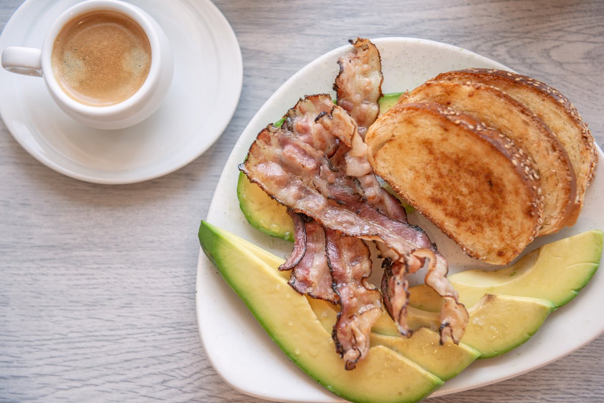 Fried bacon on white plate with cup of coffee and milk jug example image 1