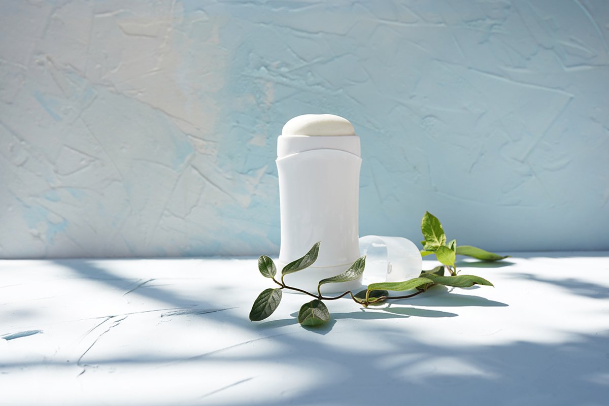 White bottle of dry deodorantat and green branch example image 1
