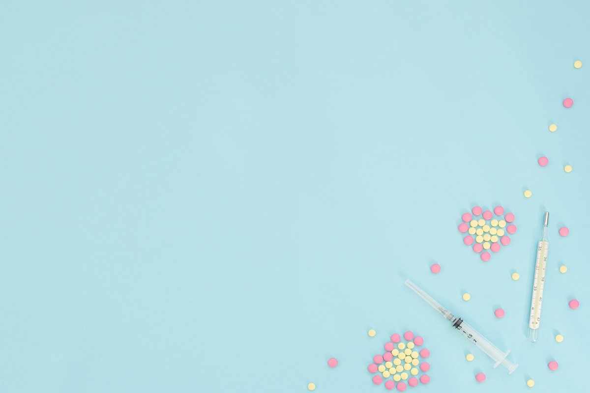 Hearts made of pink and yellow pills, thermometer, syringe example image 1