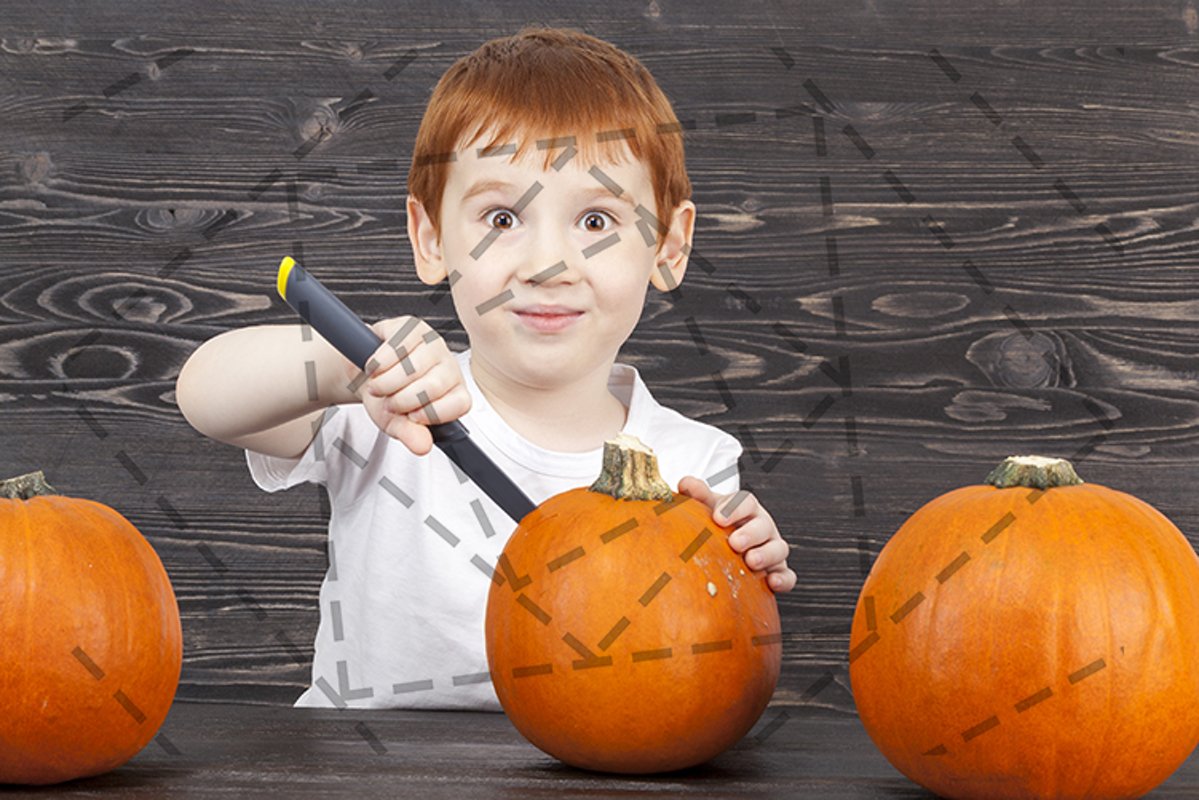 Red-haired boy cuts pumpkins example image 1