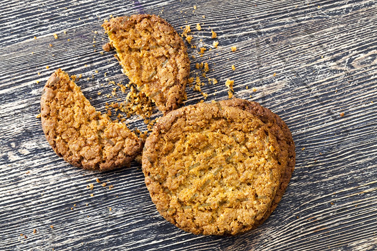 broken cookies with crumbs on the table. example image 1