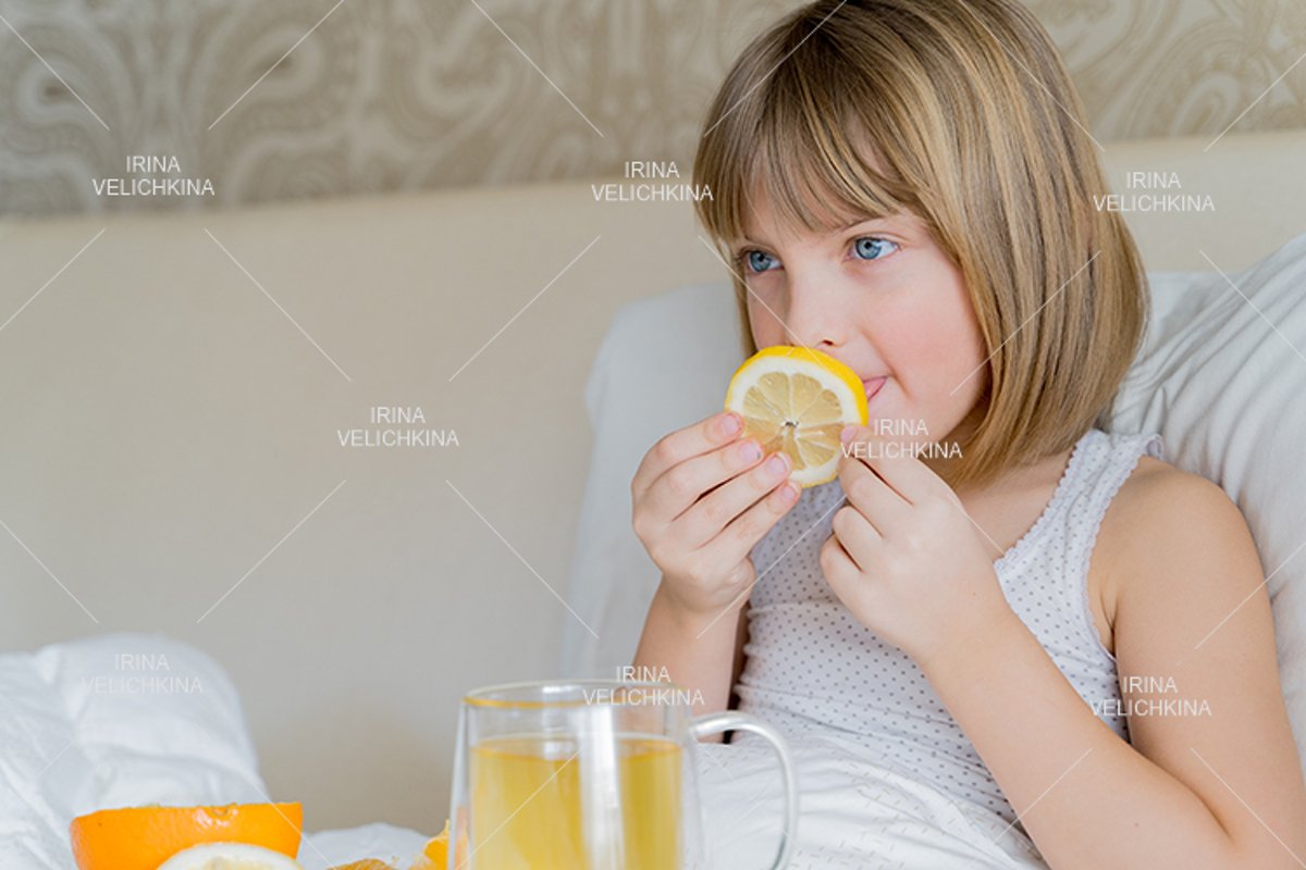 Sick girl in bed. Cup of flu drugs. Tea, orange,lemon,ginger example image 1