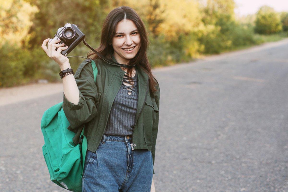 Cute brunette looks at the camera lens. A girl photographs n example image 1