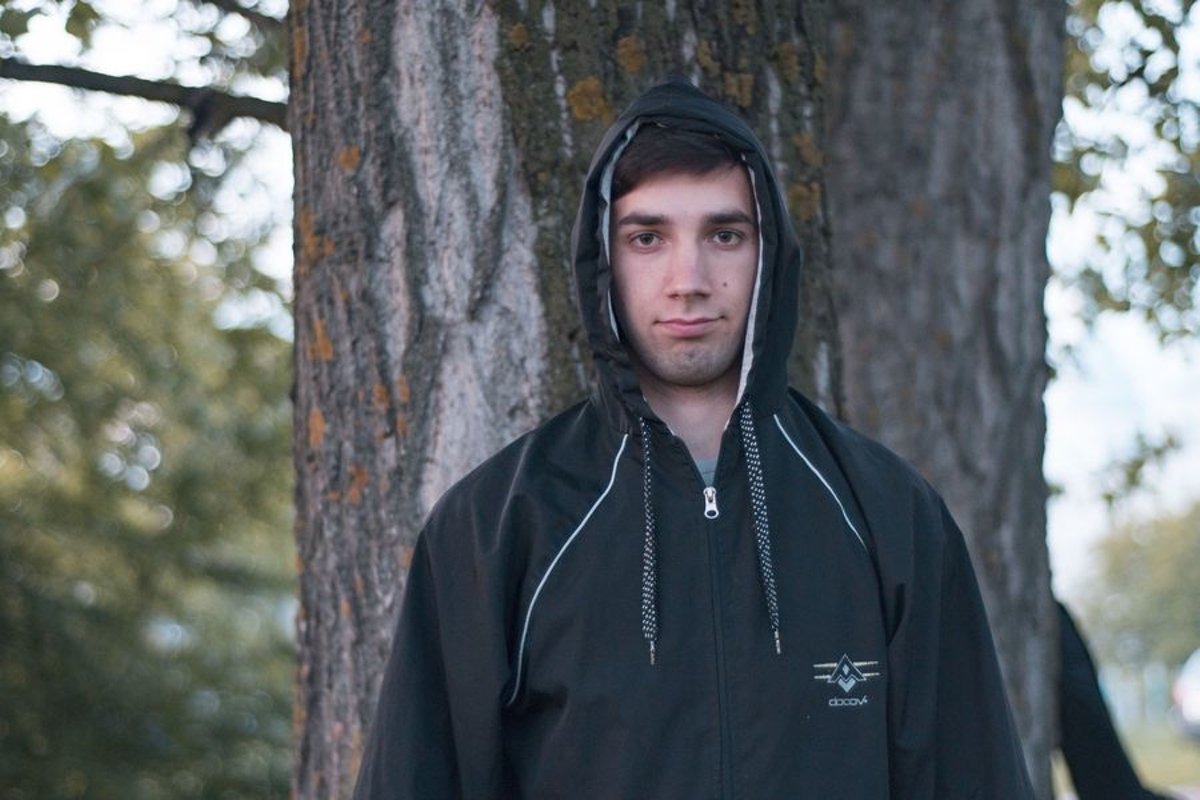 Young caucasian man walks in a park example image 1