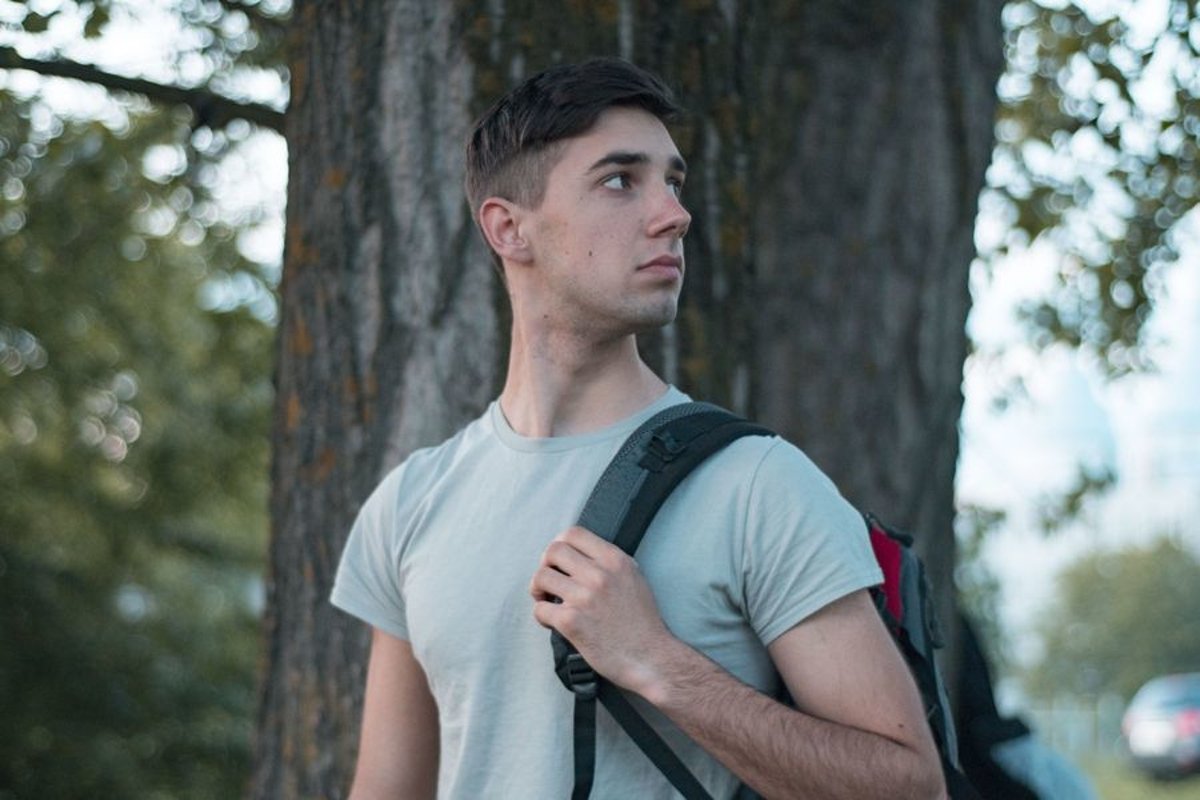 Young caucasian man walks in a park example image 1