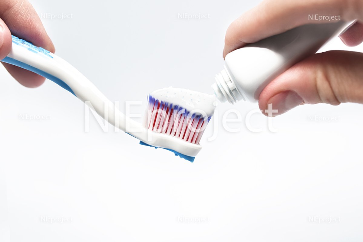 Fresh toothpaste and toothbrush in the male hands example image 1