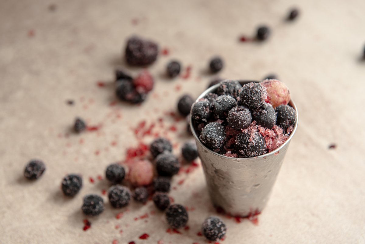 Small bucket with frozen young red berry. example image 1