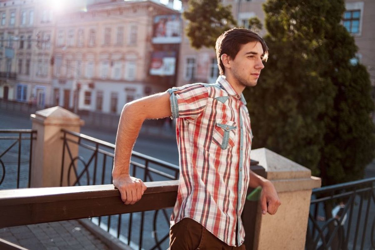 Young man walks in the city example image 1