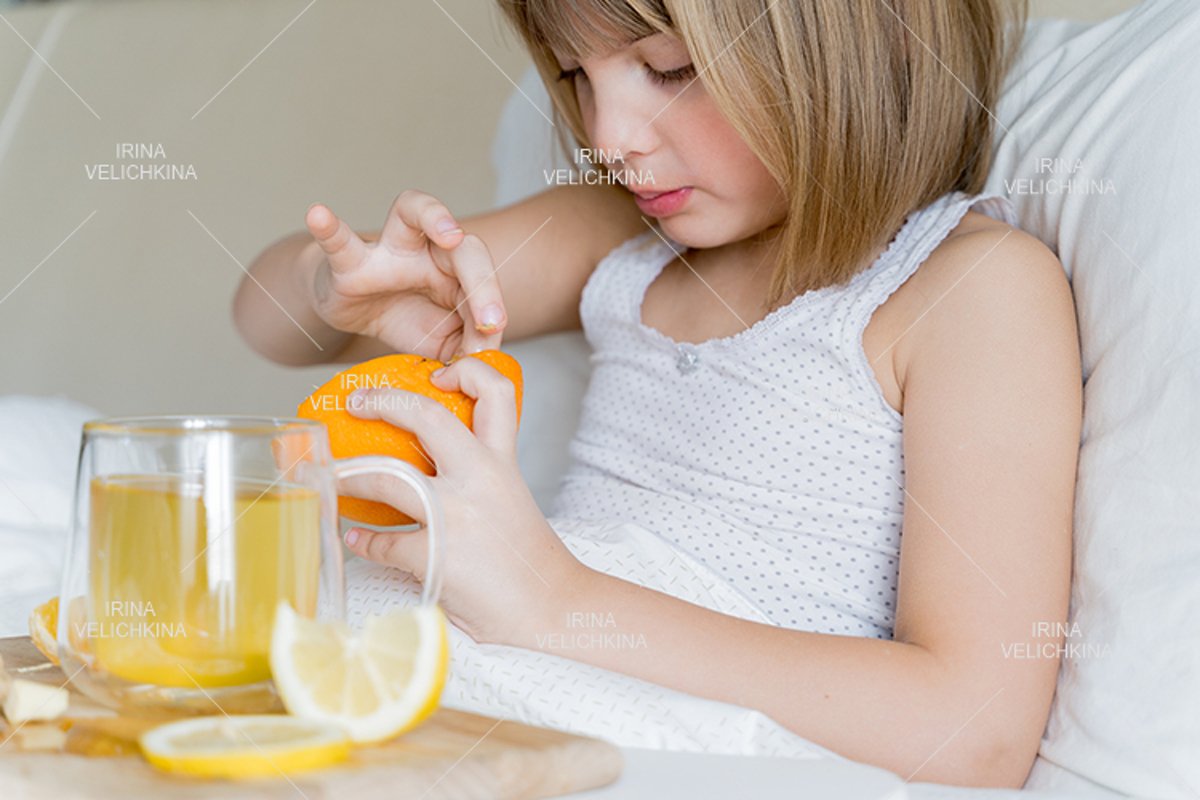 Sick girl in bed. Cup of flu drugs. Tea, orange,lemon,ginger example image 1