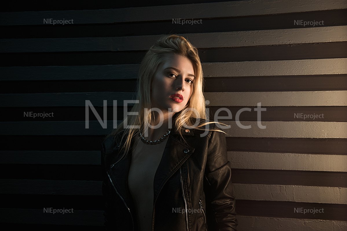 Portrait of a beautiful blonde girl posing in the studio. example image 1