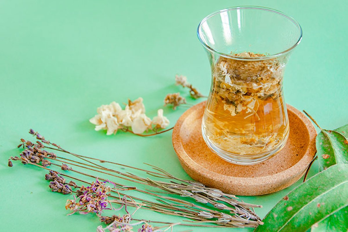 Cup of herbal tea with chamomile flowers. example image 1