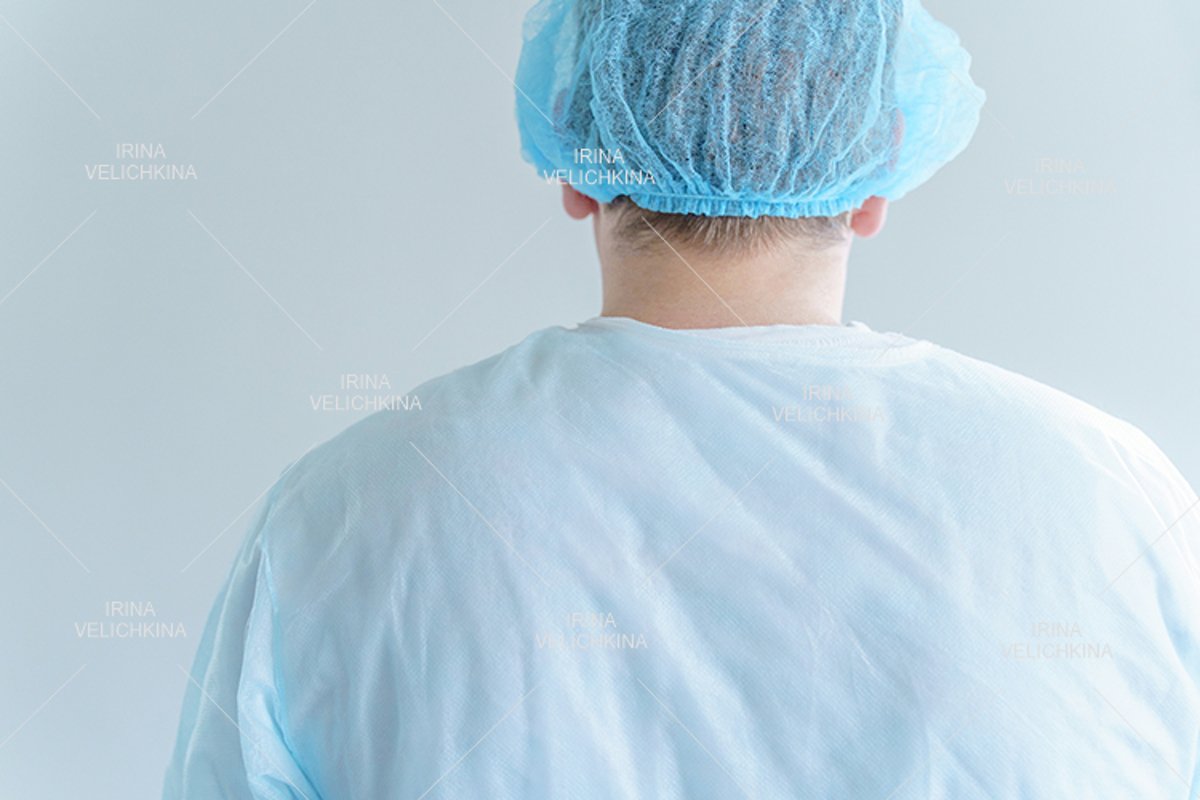 Back of doctor in medical disposable hat, robe.Working hard example image 1