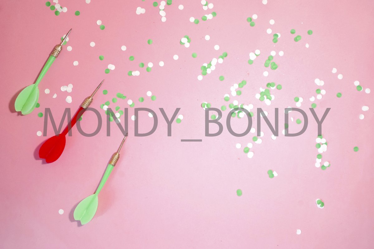 Flat lay. Darts darts and confetti on a pink background example image 1