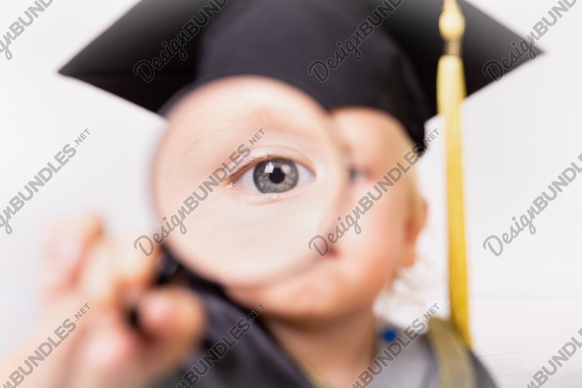 Photo of a boy looks through a magnifying glass example image 1