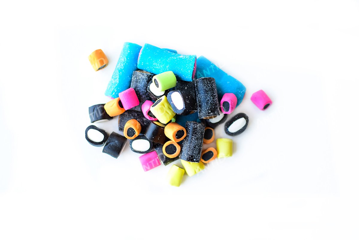 Multicolored licorice candy on a white background. example image 1