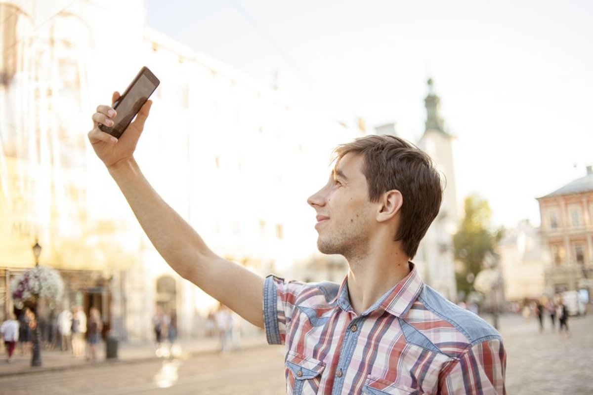 Young man walks in the city example image 1