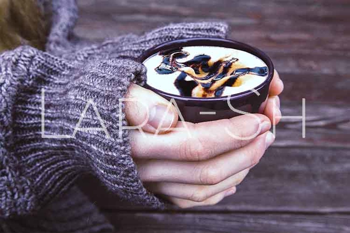 Woman holds hot cup of coffee example image 1