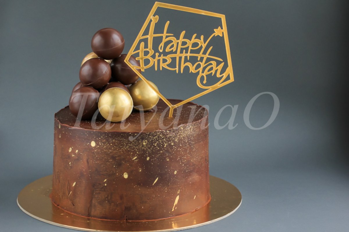 Chocolate birthday cake with gold decorations. example image 1