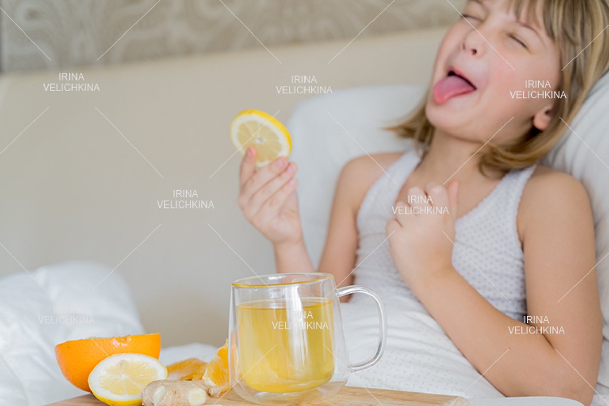 Sick girl in bed. Cup of flu drugs. Tea, orange,lemon,ginger example image 1
