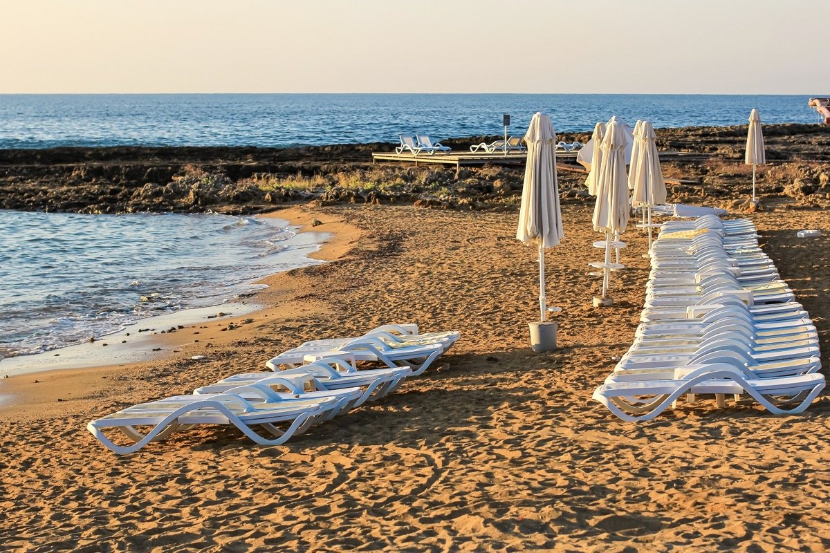 Tropical beach view with white empty chairs example image 1