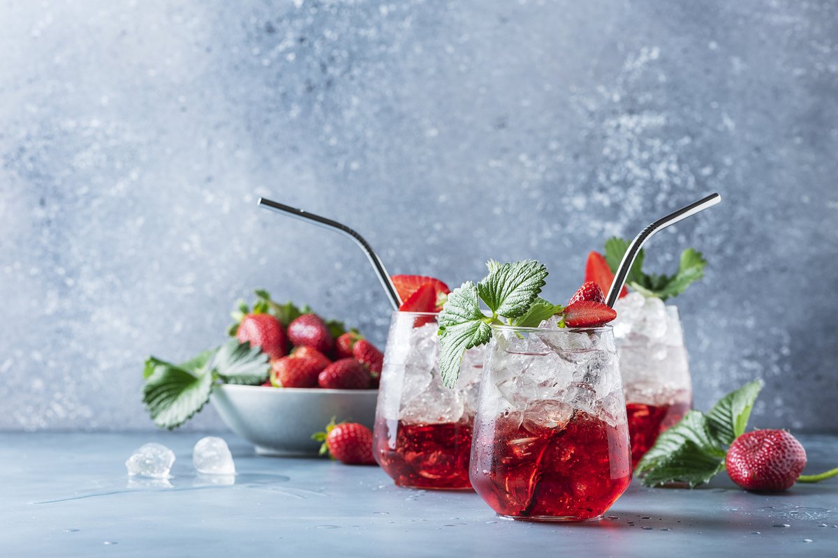 Bar concept. Red cocktail with ice and fresh strawberry example image 1