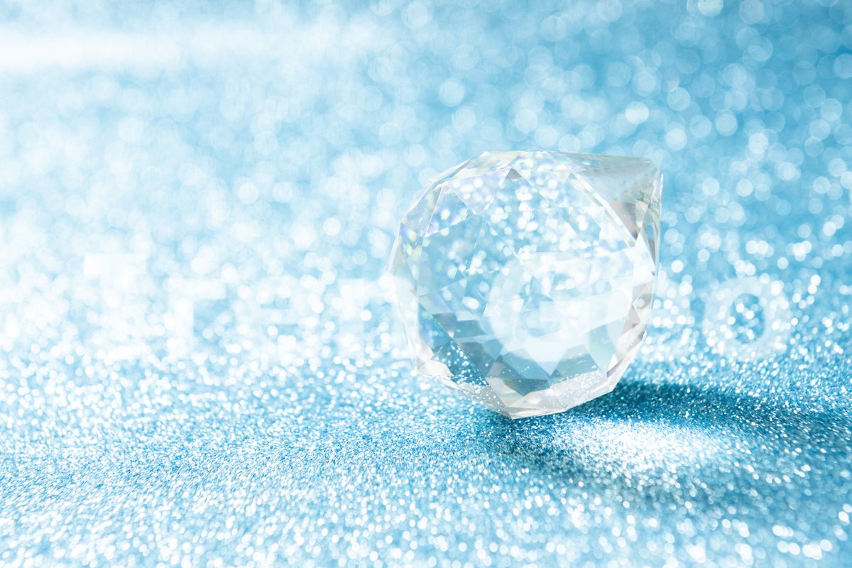 Transparent crystal in the shape of a ball on a bright blue example image 1