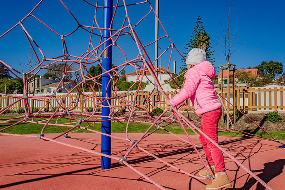 Little girl on a playground climbs upstairs. example image 1