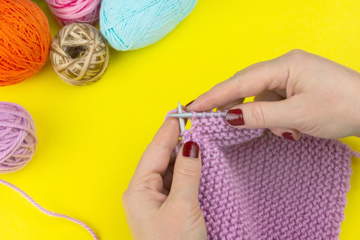 the girl knits a children's scarf on a yellow background example image 1