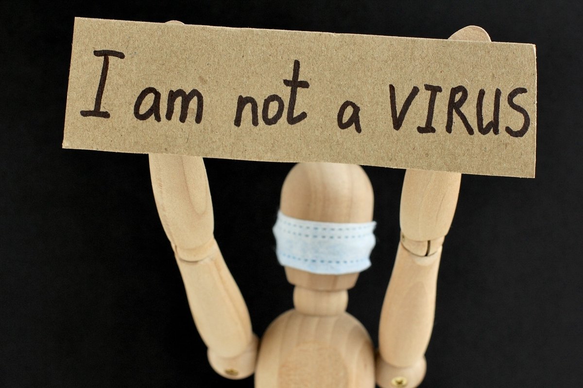 Cardboard sign with text I am not a virus example image 1