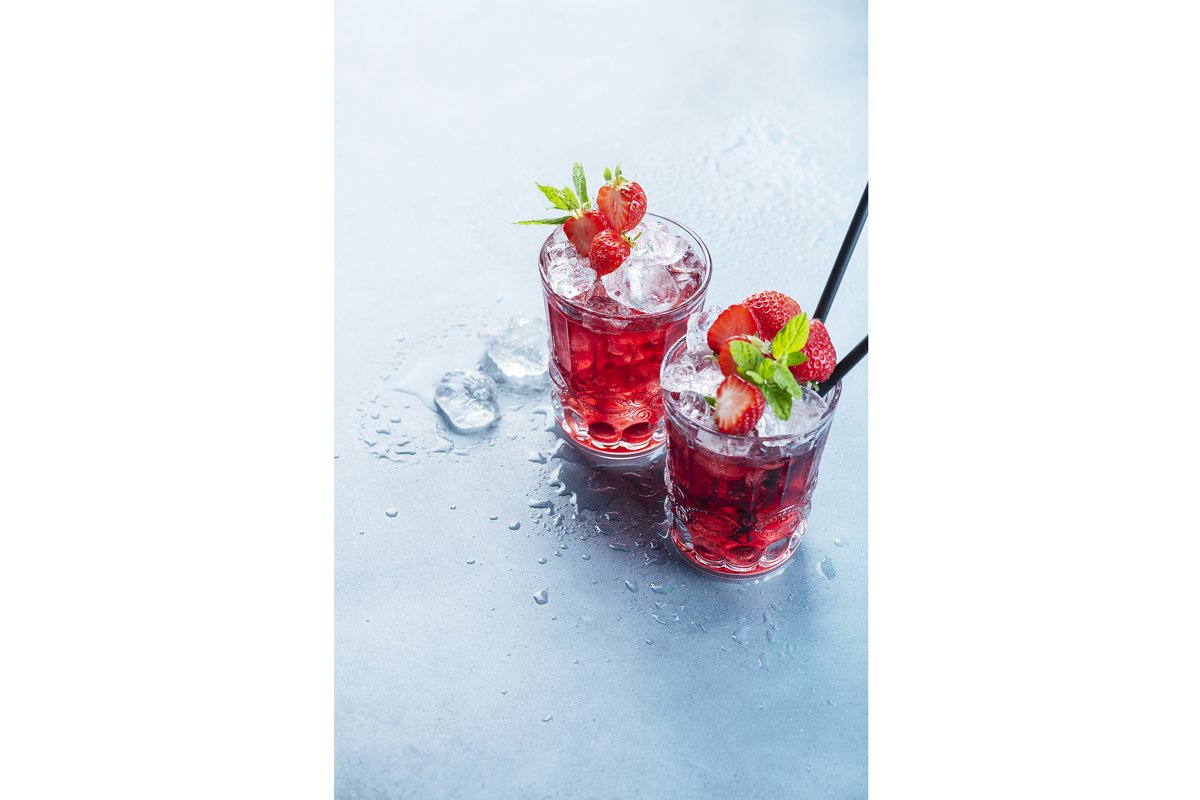 Red cocktail with ice and mint. Bar concept. example image 1