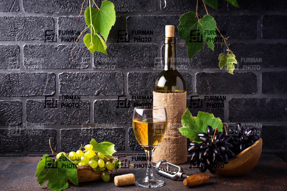Bottle and glass of white wine example image 1