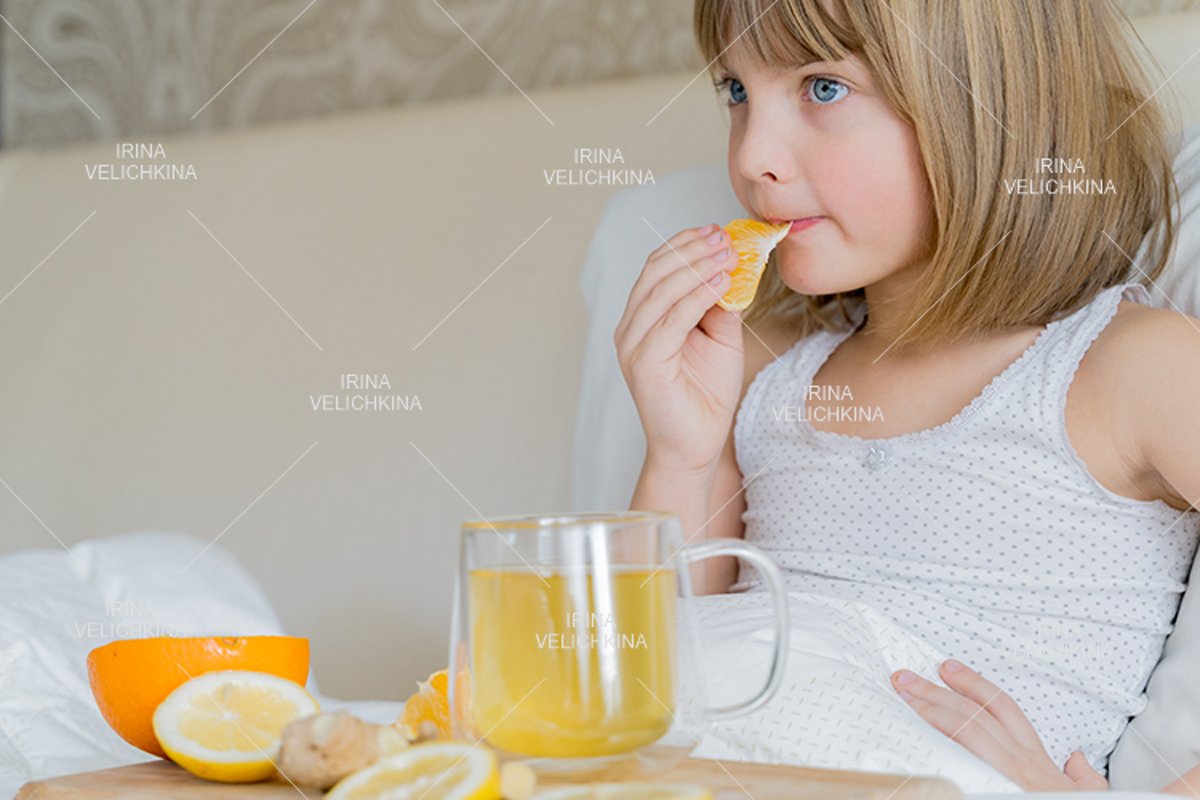Sick girl in bed. Cup of flu drugs. Tea, orange,lemon,ginger example image 1