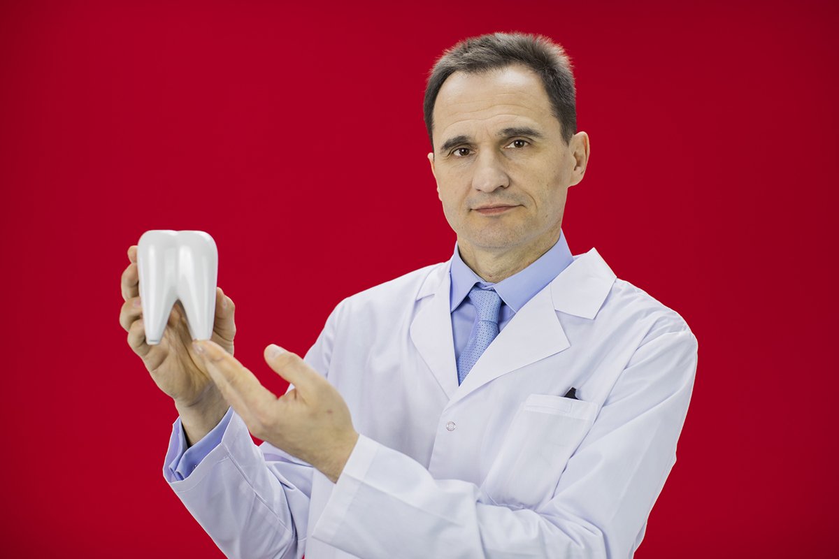 Doctor therapist with a stethoscope on a red background example image 1