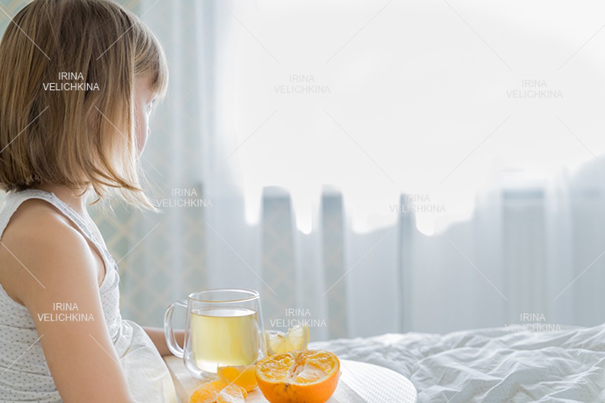 Sick girl in bed. Cup of flu drugs. Tea, orange,lemon,ginger example image 1