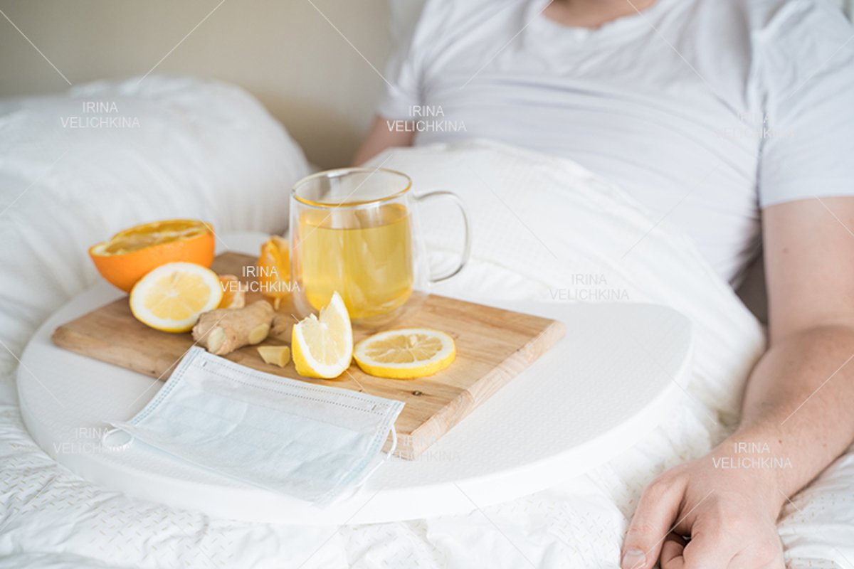 Cup of tea, orange,lemon,ginger. Face mask. Sick man in bed example image 1